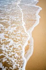 White wave on brown sand beach