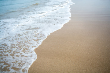 White wave on brown sand beach
