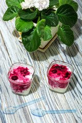 two jars of yogurt stands on the aged boards