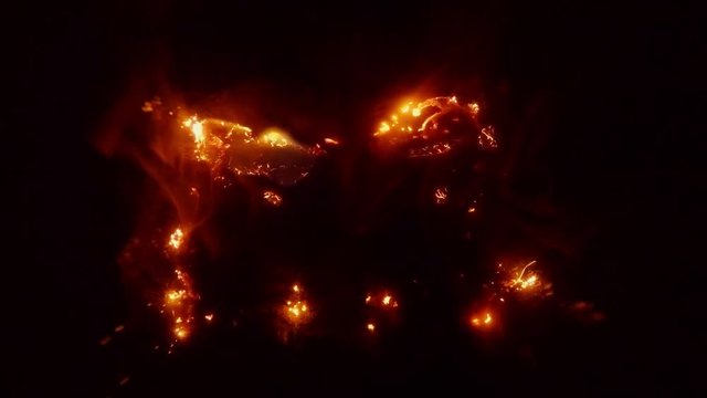 Burning Steel Wool Allocates Thin Columns of Smoke in Darkness
