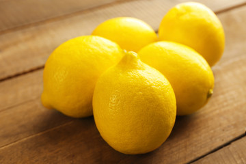 Fresh lemons on wooden background