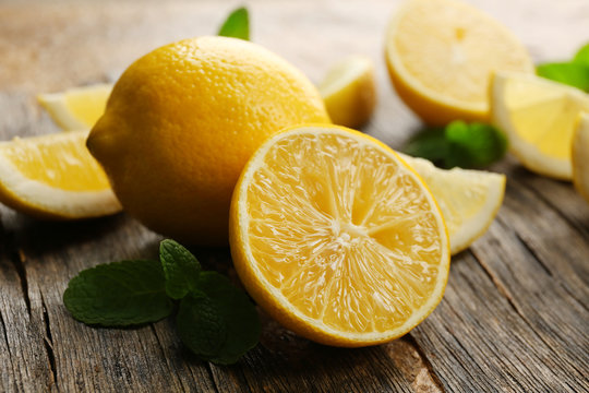 Slices of fresh lemons on wooden background
