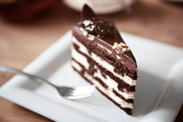 Tasty chocolate cake on table in cafe or restaurant