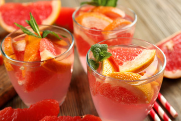 Ripe grapefruits and fresh juice with mint, close up