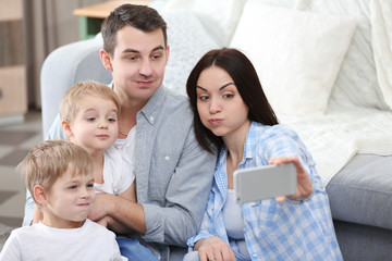 Obraz premium Happy family making selfie on couch background