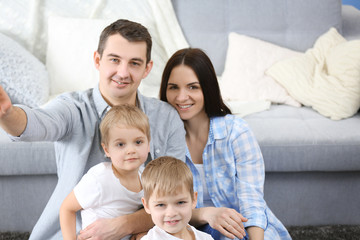 Obraz premium Happy family making selfie in new house