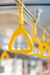 Handles on ceiling for standing passenger inside a bus