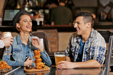 Group of young people spending time in bar