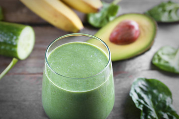 Fresh avocado smoothie on wooden background