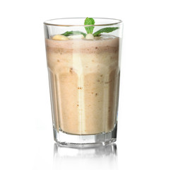 Glass of fresh banana cocktail on glass surface