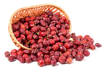 Dried rose hips in wicker basket isolated on white background
