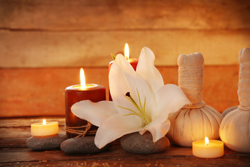 Obraz na płótnie Canvas Spa set with lighted candles on wooden background