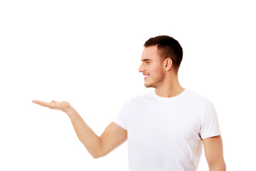 Young man showing something on palm