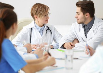 Fototapeta premium Medical doctors sitting at the meeting in modern hospital