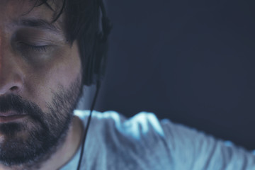 Man listening to music with eyes closed