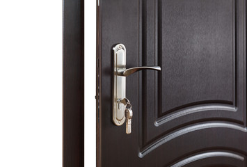 Closed dark brown wooden door handle with lock. 