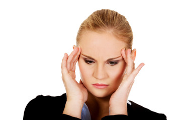 Business woman with a huge headache holding head