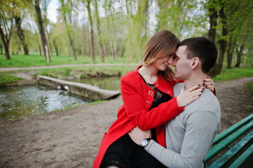 Fototapeta premium Face to face of lovely couple sitting on bench at park