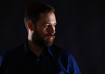Fototapeta premium Cool businessman standing on dark gradient background