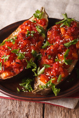 Turkish Cuisine: Half of eggplant stuffed with vegetables close-up. Vertical
