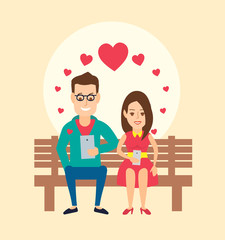 loving couple man and woman sitting on bench with gadgets tablet and smart phone