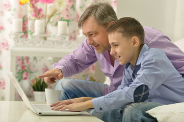 Father and son with laptop