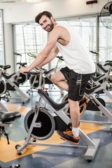 Fototapeta na wymiar Fit man using exercise bike