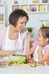 Mother and daughter cooking dinner