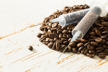 Health care concept - coffee beans in plastic syringe