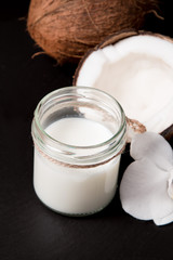 Coconut Milk in a glass on dark background