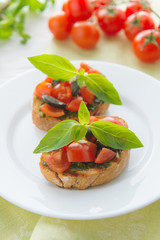 Italian tomato bruschetta with chopped vegetables, herbs and oil