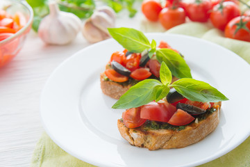 Italian tomato bruschetta with chopped vegetables, herbs and oil