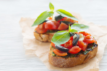 Italian tomato bruschetta with chopped vegetables, herbs and oil