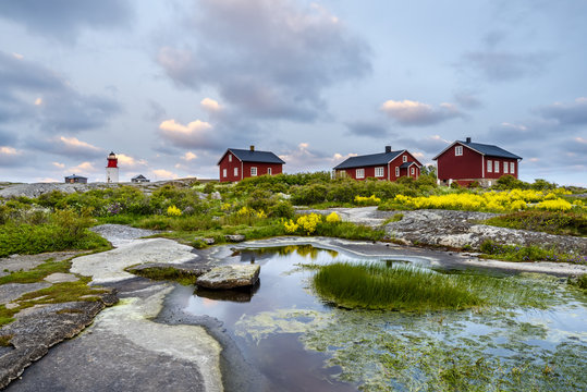 Falun red cottages and lighthouse in background