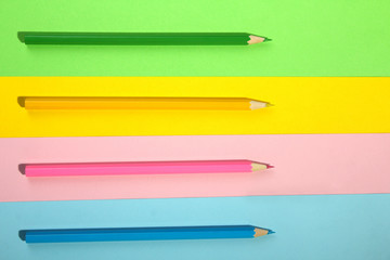 pink and yellow with green and orange pencils on light pink and yellow with green and orange background