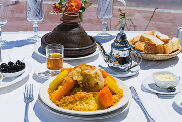 Moroccan traditional dinner: Kuskus, tajin, mint tea and olive.