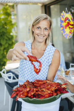 Mature woman with bowl of crayfish