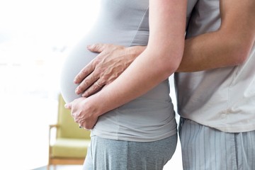 Man holding pregnant womans stomach