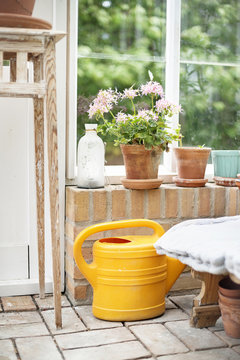 Watering can in conservatory