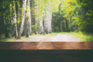 Empty top wooden table and floral blurred background