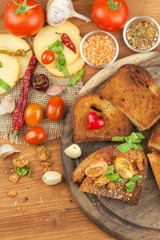 Fried bread with garlic and tomatoes. Toast to eat. Domestic food preparation. Quick to prepare meals for guests.
