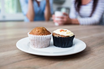 Muffin and cupcake served in plate on table