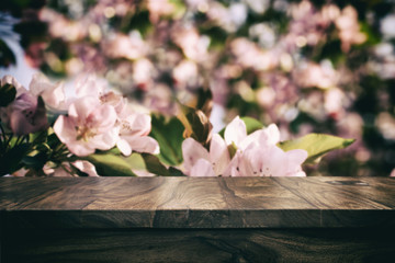 Empty top wooden table and floral blurred background