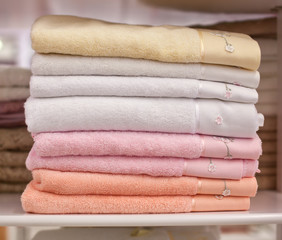 Pile colored of terry towels on the shelf