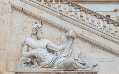 Obraz premium Statue of god(Tiber) with cornucopia at square Piazza del Campidoglio.Part of the sculpture composition of the Fountain of Goddess Rome.Work by Matteo di Castello.Capitol hill.Rome.Italy.Europe