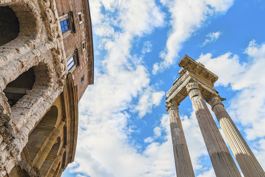 Beautiful view on the ancient Theatre of Marcellus( Teatro di Marcello ) and ruin of old building( antique columns and detail of the cornice ) next to it on the background of clouds.Rome.Italy.Europe.