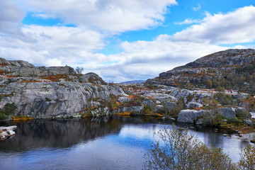 Tarn between the fell sides on the hiking way to the Pulpit Rock in Norway