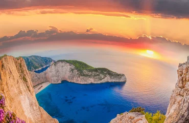 Cercles muraux Plage de Navagio, Zakynthos, Grèce Navagio beach with shipwreck and flowers against sunset on Zakyn