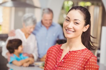Happy woman with family in kitchen