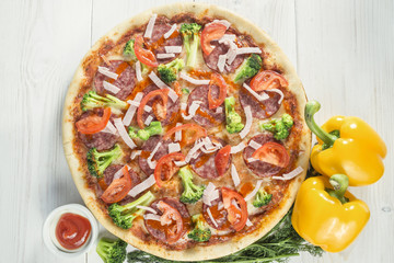 tasty Pizza on wooden table background. Top view with copy space
